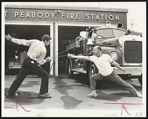 The form is perfect, though the setting is a bit unusual, as Joe Pechinsky, left, squares off with Steve Boston in front of the West Peabody firehouse.