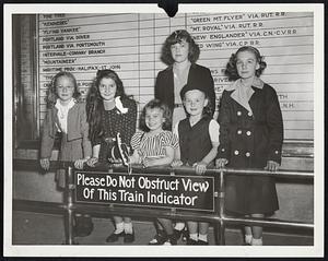 These Lassies Stranded in North Station couldn't get any attention even by standing in front of this sign. Left to right: Anne M. Howard, Thersia Dobson and Anne Dobson, all of Gardner.