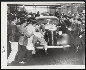 Car Bucks Picket Line – An automobile carrying night shift workers leaving the strikebound Allis Chalmers plant in Milwaukee this morning forces its way through a picket line as police attempt to hold back United Auto Worker – CIO pickets.