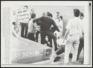 Draftees Maul Anti-Draft Pickets-- An unidentified anti-draft picket goes to his knees and a draftee who had reported to the induction center on Chicago's Van Buren St. aims a kick at him today as the draftees suddenly attacked the pickets. Other pickets carrying anti-draft signs are in de background.