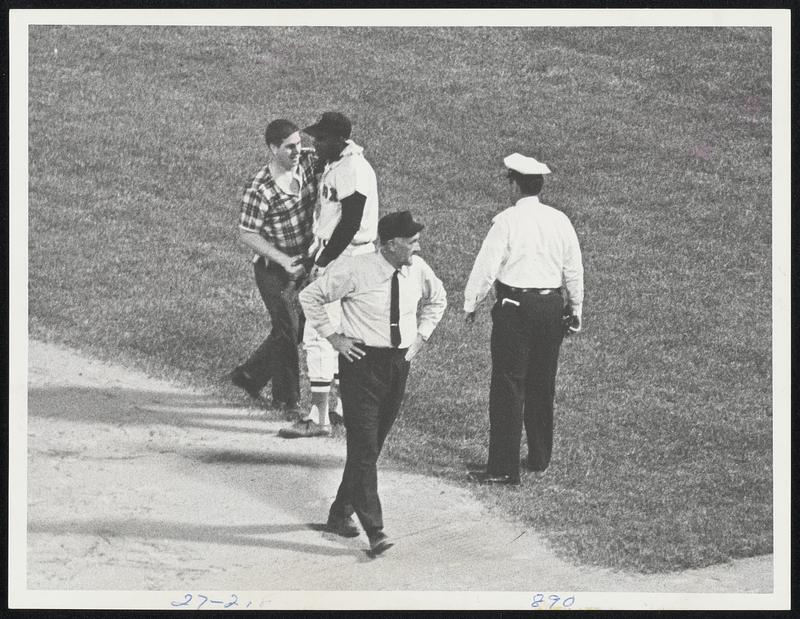 Happy Fan visits George Scott in ninth inning of Fenway Park nightcap after shaking hands with five other Red Sox players. Umpire is Ed Runge.