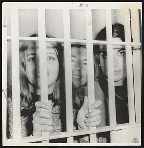 Three coeds (top right) smile through prison bars in Oakland after being arrested for taking part in day-long protest against rules restricting campus political activity.