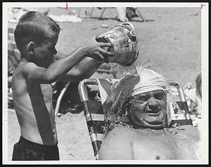 At Wollaston Beach, Robert Ryan, 5, helped John O'Toole by dumping water on his head...