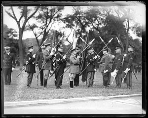A group of men in military uniform holding pikes