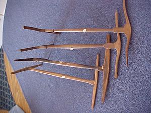 Four wooden hay forks
