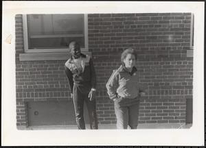 Two teenagers standing outside