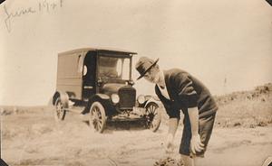 Arthur S. Graham clamming on beach in front of Cape Cod Laundry truck, West Yarmouth, Mass.