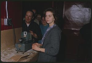 Group gathered around slide projector