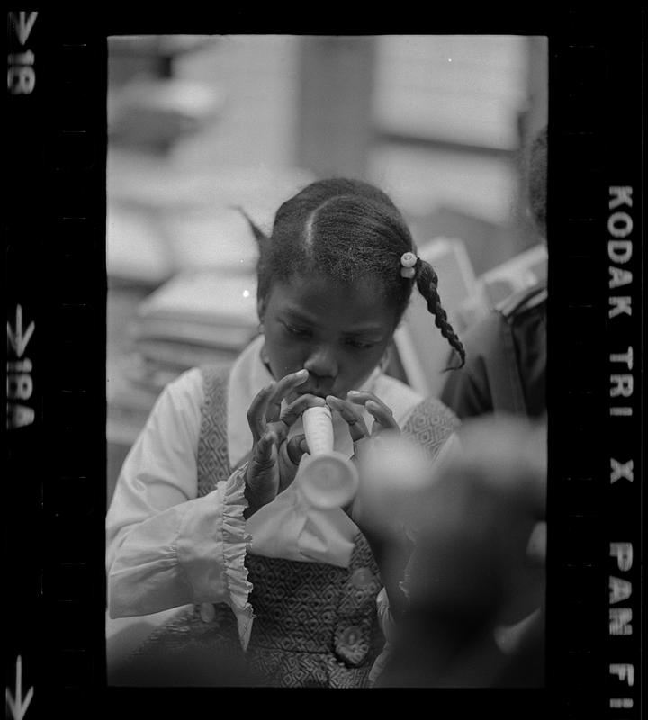 Black schoolchildren play recorders, Roxbury