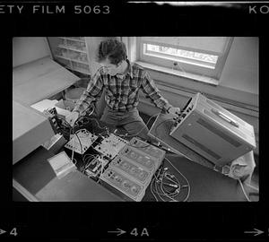 Man adjusts electronic equipment