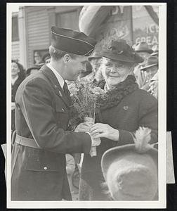 Kerrigan Day in South Boston... Mayor John E. Kerrigan, South Boston's own, is shown as he presented his mother Mrs. Annie Kerrigan, a bouquet of flowers along the route of the parade, where the mayor stole the spotlight. It was Johnnie Kerrigan Day in Southie.