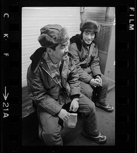 Two seated men in fur hats, North Slope camp, Anchorage, Alaska