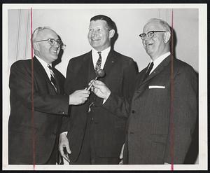 Baptist Social Union retiring president, Lewis M. Foster, left, hands gavel to successor, Chester W. Abbott, at 98th dinner meeting of Boston organization. They flank the Rev. Dr. Edwin H. Tuller of Valley Forge, Pa., executive secretary of the American Baptist Convention, principal speaker.