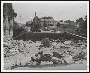 End of the Road-In Putnam, Conn., this washout smashed street around abutment of Providence Street Bridge. Scenes like this were common in Putnam, Waterbury and other Connecticut cities.