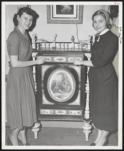 Musical Antique-This $5000 porcelain cabinet plays musical tunes when its doors or drawers are opened, these pretty visitors discovered as they browsed about the Antique Show opening today at the Somerset Hotel and lasting through Wednesday. The young ladies: Miss Patricia Hyde (left) and Miss Mone Bloom, both of Boston.