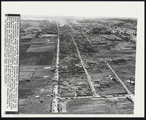 After Tornado Struck Flint in 1953-This was the vast devastation scene 10 years ago at Coldwater Road (top to bottom) and Kurtz Road (bottom), in Flint, Michigan, after a huge tornado smashed along Coldwater at dusk. The tornado killed 116 persons, injured 867, demolished 340 homes and 27 business places costing $19 million in damage. Today is the tenth anniversary of Flint's most tragic disaster.