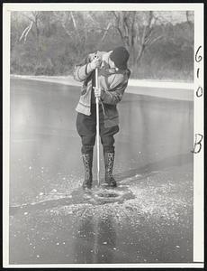 Fred Bleiler cutting hole to set Trap ice fishing Dover Mass.