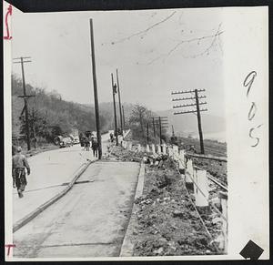 Sliding Highway-At Pittsburgh a 600-foot hill has ended its week-long slide after slipping 12 feet toward Allegheny river, and carrying with it three houses, part of highway and railroad tracks. The slide was caused by heavy rains penetrating clay strata.
