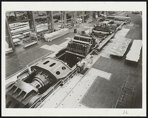 Stretches Alumnum-This giant machine, in the Reynolds Metals plant at McCook, Ill., can literally stretch aluminum plate up to six inches thick, 90 feet long and 12 feet wide. It has the power of 230 diesel switching engines.