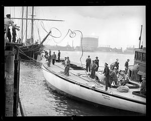 Ropes being thrown between "Whirlwind" and dock