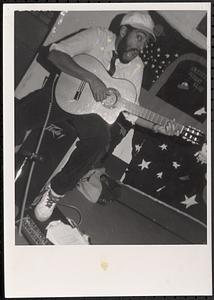 "Big Mouth" (Vince), theater program teacher, playing the guitar