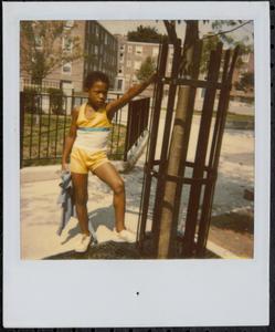 Boy in yellow posing in Newtowne Court