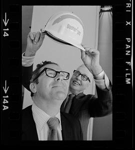 Happy BostonGas executive gets a "promotional" hard hat, downtown Boston