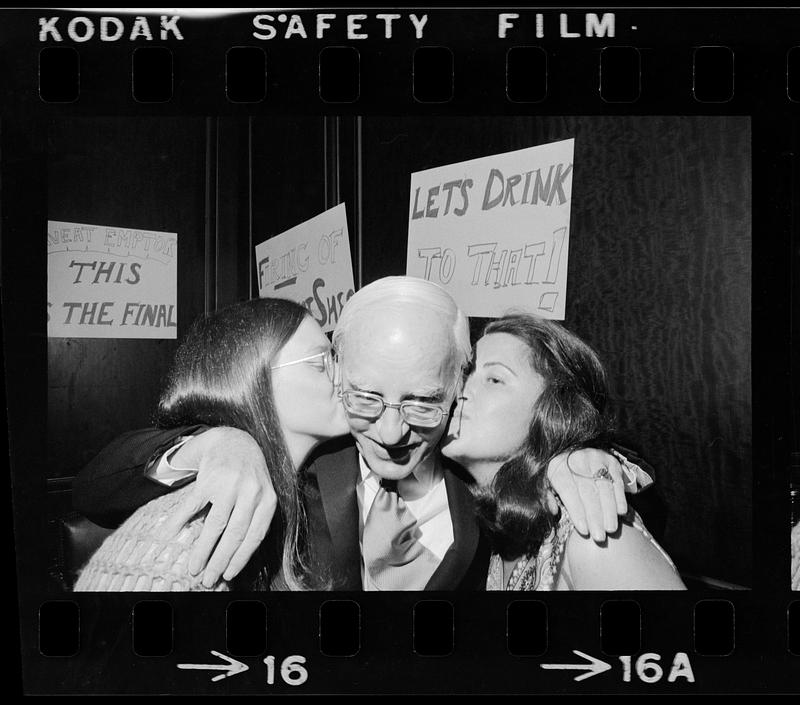 An elderly lottery winner gets kissed for the cameras, Boston TV studio