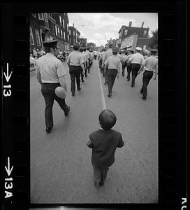 Boy follows 4th of July parade marchers, Charlestown