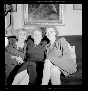 Three women posing on couch