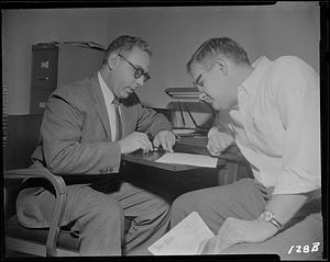 Two men looking at a document