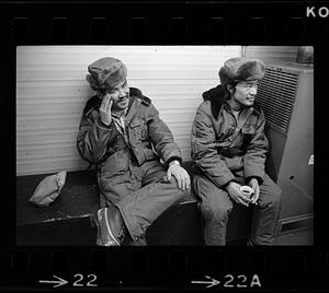 Two seated men in fur hats, North Slope camp, Anchorage, Alaska