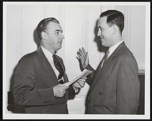 George M. Abagis of Everett, right, a Boston attorney, is shown taking the oath of office as Selective Service Government Appeal Agent. Lt. Summer G. Whittier administered the oath.