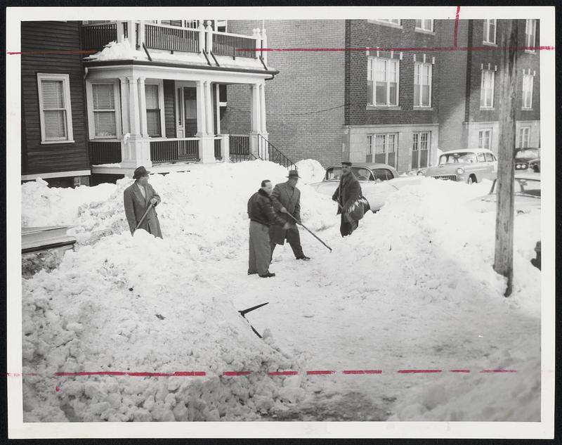 Do-It-Yourself shovelers -- Men of Calder street, Mattapan, waited and waited for the city plows but they never came. So, attacking the drifts are, left to right, Julian Goulston, Simon Hadley, Ernest Beltramine and James Hanlon. They did not say whether they would bill the city for the work.