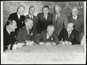 Executive Map Baseball War Effort -- Planning baseball's part in the nation's was effort at a meeting here today are (left to right)(seated): Lt. William Huggins, U.S.N.; Col. John Taylor, A.U.S.; Judge Kenesaw Mountain Landis; baseball commissioner; Stanton Griffis of the Navy Relief Society; (standing) William Harridge, American League President; Leslie O'Connor, Landis' secretary; Ford Frick, National League President; Frank Shaughnessy, International League President; William G. Bramham, National Association of Profecional Baseball Leagues President.