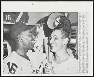 Home Run Hitting Pitcher-- Chicago White Sox third baseman Al Smith (left), who knocked a home run in first inning, doffs the cap of pitcher Ray Herbert, who also slammed a homer, in third inning, during a congratulation session in the dressing room after their 3-2 victory over the Minnesota Twins in an American League game today in Twin Cities. Herbert was also the winning pitcher, Both homers were with empty bases.