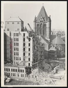 Boston Landmark – The old Hotel Westminster in Copley Sq., more recently an insurance office, is shown being torn down. The spire of Trinity Church can be seen in the rear of the old landmark.