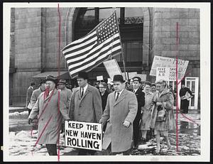 Jobs at Stake--New Haven Railroad workers whose jobs may hinge on whether the legislature agrees to subsidize the railroad and avert bankruptcy, leave South Station to march on Beacon Hill as subsidy hearings opened.