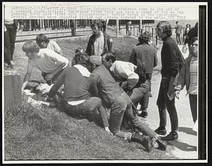 Kent State University students come to the aid of a wounded youth.National Guardsmen fired tear gas into a crowd of 500 on the commons. Shots were fired when demonstrators hurled rocks at the guardsmen. Several persons were reported killed and others injured in the melee.