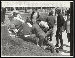 Kent State University students come to the aid of a wounded youth. National Guardsmen fired tear gas into a crowd of 500 on the commons. Shots were fired when demonstrators hurled rocks at the guardsmen. Several persons were reported killed and others injured in the melee.