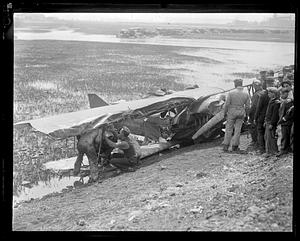 People examining a wrecked airplane