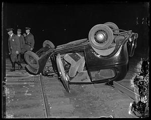 Car overturned by railroad tracks