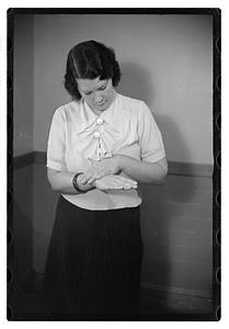 A woman looking down at her hands