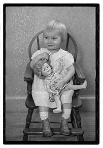A girl holding a doll