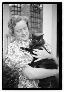 A woman holding a cat