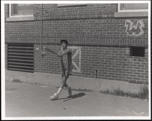 Boy hitting a baseball with a bat