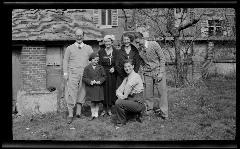 Samuel Chamberlain holding a racquet and posing with group of adults and a child