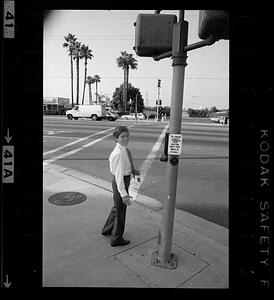 Boy waits to cross street, Anaheim, California