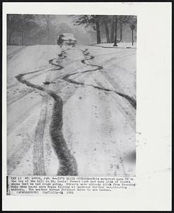 St. Louis - It's Slick Outside - This motorist made it to the top of the hill in St. Louis' Forest park but wavy line of tracks shows that he had rough going. Streets were already slick from freezing rain when heavy snow began falling at daybreak further complicating matters. The weather bureau forecast three to six inches.