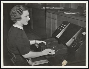 Voder' You Know About That. Pardon the pun, but humanity is helpless before the onward rush of science. The attractive young woman seen above is Mrs. Helen Harper, and far from listening to Bing Crosby on the radio as you might suppose from the dials in front of her, she is operating the Voder, the first machine in the world to create speech -- no "canned talk" or recording. Speech isn't all -- the Voder can hiss, too. The demonstration took place at Franklin Institute, Philadelphia, before scientists.